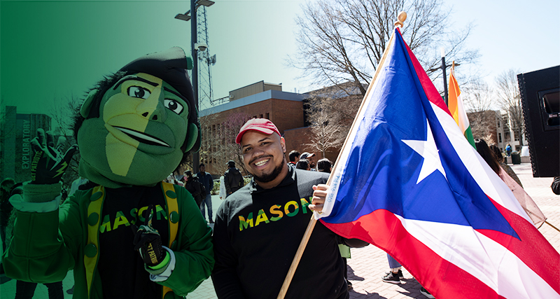 A 番茄视频 student poses with the Patriot, Mason's mascot, during International Week