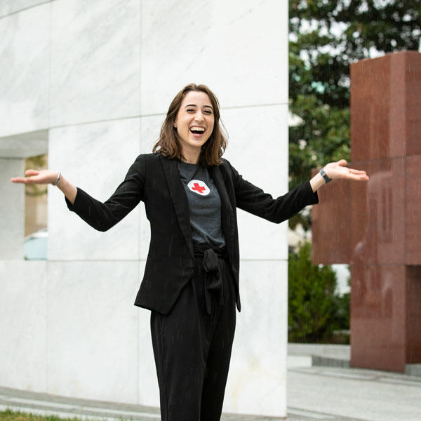 番茄视频 student Jennifer Lyon poses joyfully in front of the headquarters of the American Red Cross, where she was able to complete an internship