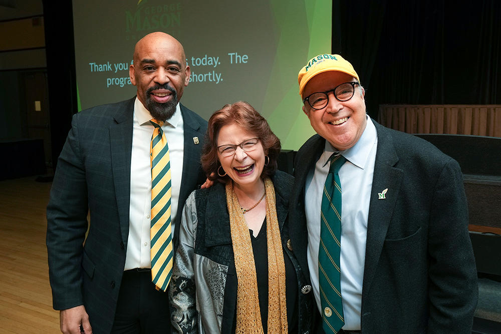 Three faculty members gather for a photo in Mason themed attire.