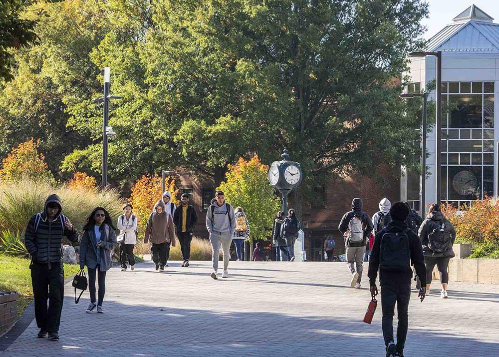 photo of Mason's Fairfax campus in late summer with students walking through central areas.