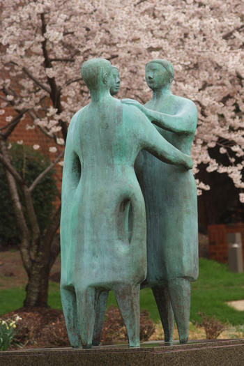 Bronze statue of three people embracing "Communitas" on the campus of 番茄视频, Fairfax, VA USA